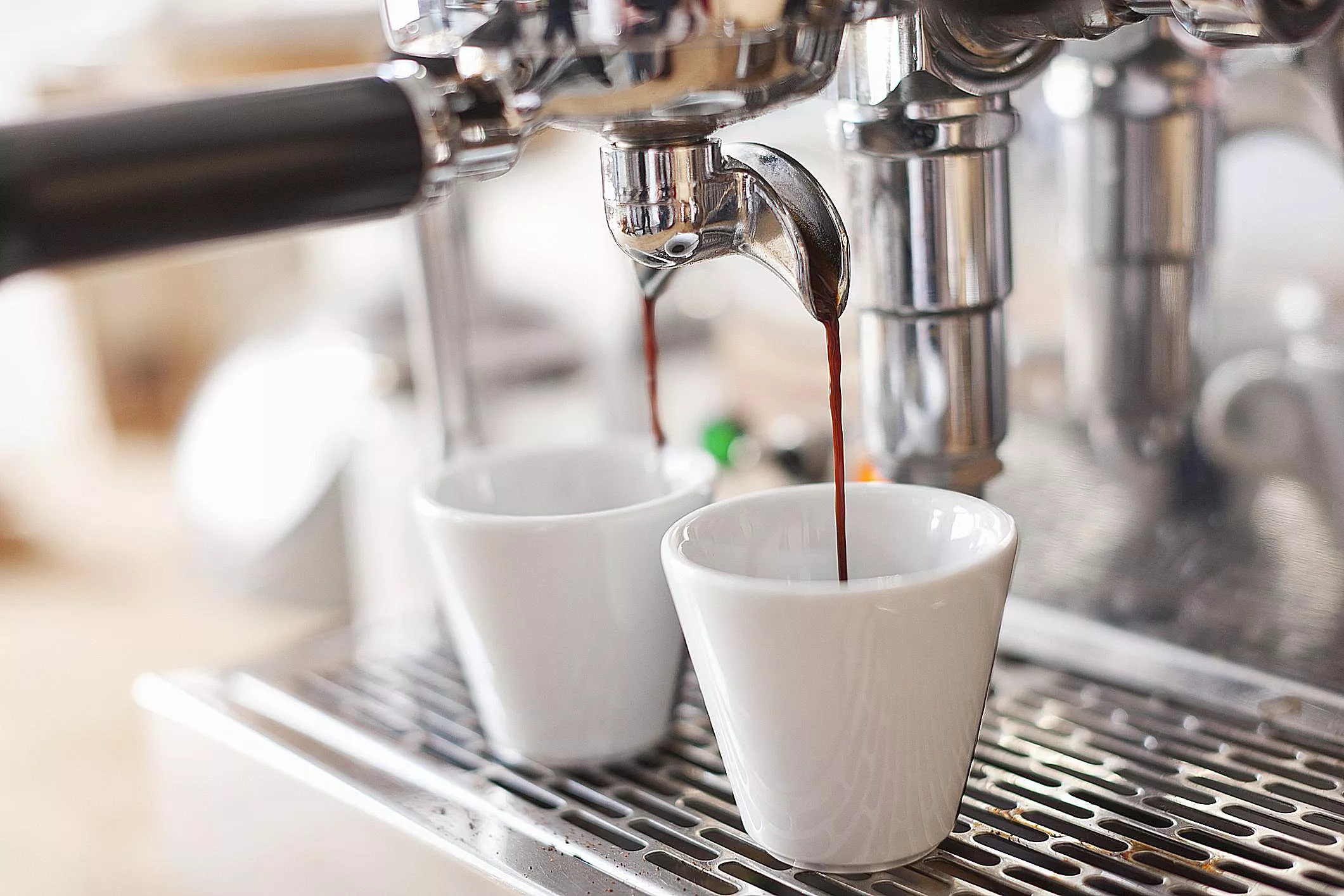 Espresso being dropped into cups