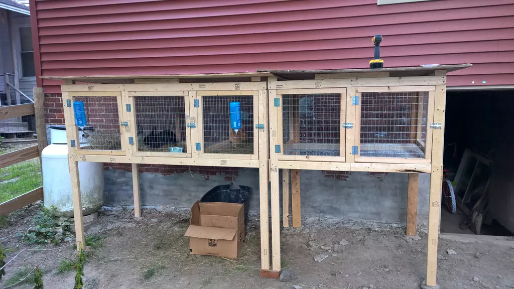 A sectional rabbit hutch with five separate entrances.